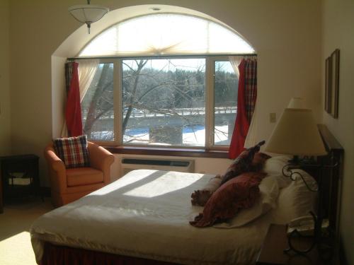 a bedroom with a bed with a dog laying on it at Benmiller Inn & Spa in Goderich