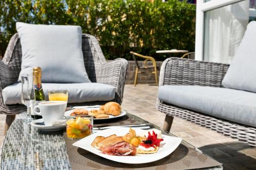a table with a plate of food on a patio at Nura Santa Ponsa & Spa in Santa Ponsa