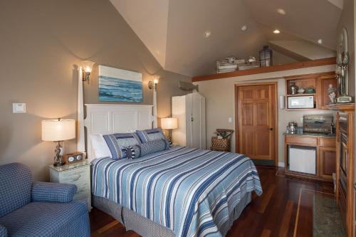 a bedroom with a bed and a chair in it at Moonstone Cottages in Cambria