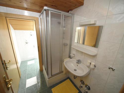 a white bathroom with a sink and a shower at Frühstückspension Kärntnerhof in Malta