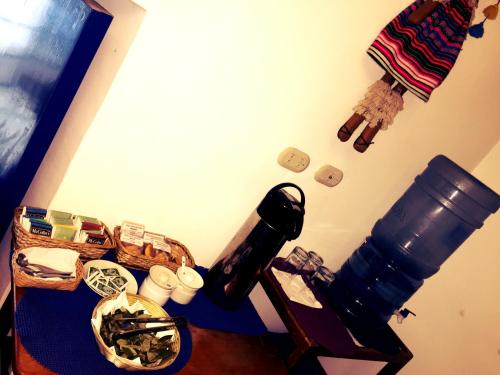 a room with a table with a microscope and cups at Rumi Wasi in Cusco