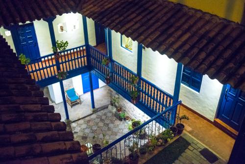an overhead view of a building with blue doors and stairs at Rumi Wasi in Cusco