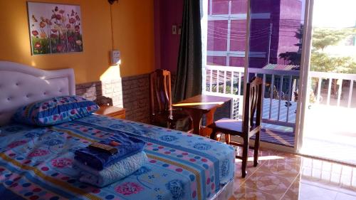 a bedroom with a bed and a balcony at Rueangsrisiri Guesthouse 2 in Sukhothai