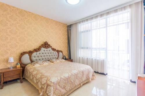 Postel nebo postele na pokoji v ubytování Sanya Passion fruit Inn