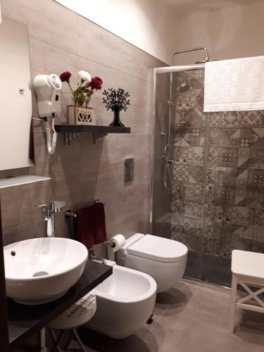 a bathroom with a toilet and a sink and a shower at AL-ZABUT in Sambuca di Sicilia
