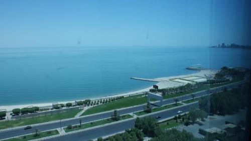 an aerial view of a road next to a body of water at Costa Del Sol Hotel by Arabian Link in Kuwait