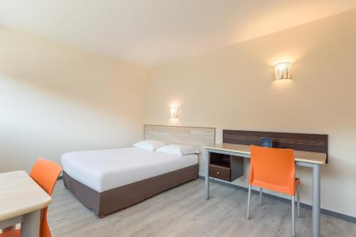 a hotel room with a bed and a desk at City Résidence Bordeaux Centre in Bordeaux