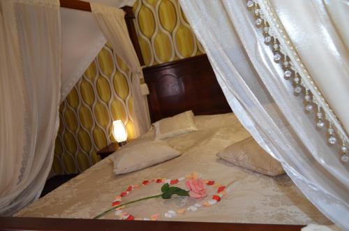 a bed with a plate of flowers on it at Golden Palace in Dubove
