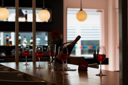 a table with wine glasses and a bottle on it at Park Inn by Radisson,South Delhi in New Delhi