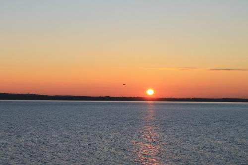 a sunset over a large body of water at Suite Mavino Appartamenti in Sirmione