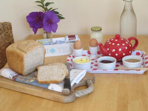 a tray with bread and eggs on a table at Little Paradise & Petting Farm in Greymouth