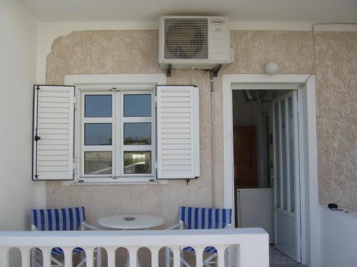 a room with a table and chairs and a window at Margarita in Perissa