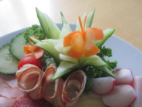 a plate of food with vegetables and fruit on it at GästeHaus Rudolf u. Sandra DENK in Wösendorf