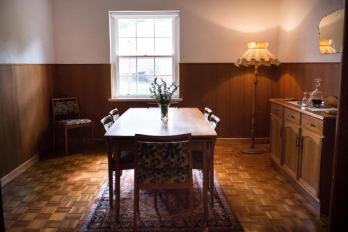 eine Küche mit einem Tisch mit Stühlen und einem Fenster in der Unterkunft Hanisch Haus in Tanunda