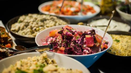 a table topped with bowls of food on a table at Thon Hotel Nordlys in Bodø