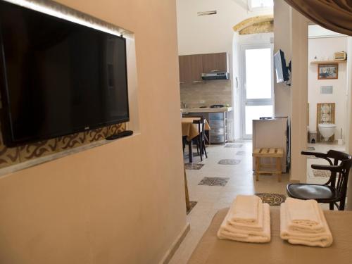 a living room with a flat screen tv on a wall at La Culla di Adeodata in Marsala