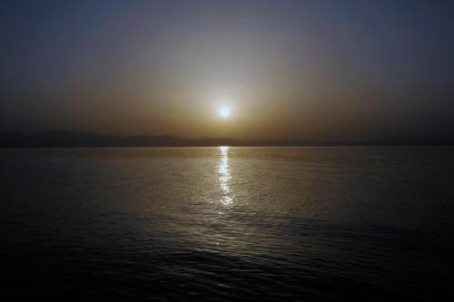 a sun setting over a large body of water at Daniela Diving Resort Dahab in Dahab