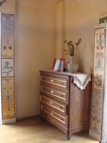 a dresser in a room with a vase on top of it at Antico Casale dei Sogni agriturismo in Lugo