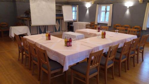 a large dining room with a long table and chairs at Landhotel Schnupp in Neudrossenfeld