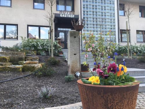 a flower garden in front of a building at Landhotel Schnupp in Neudrossenfeld