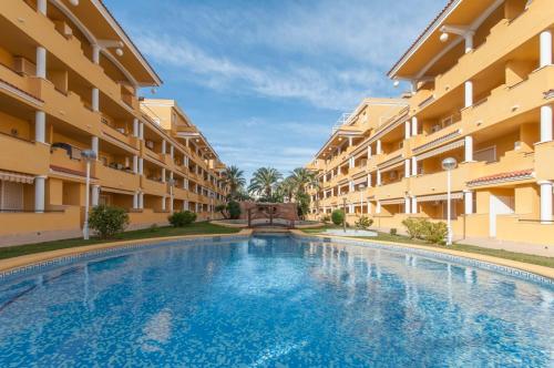 a swimming pool in front of a building at Cascades in Denia