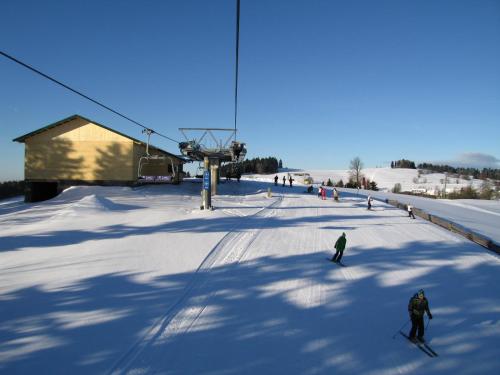 a group of people skiing on a ski lift at Pension Imlauf in Vrchlabí