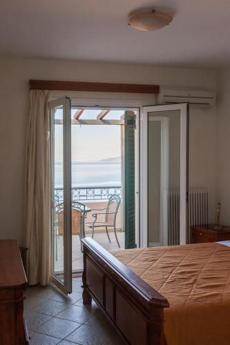 a bedroom with a bed and a view of the ocean at Epidavros Seascape in Ancient Epidavros