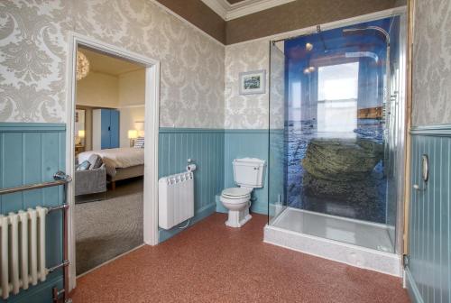 a bathroom with a toilet and a walk in shower at Sea breeze in Whitby