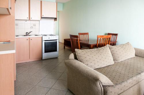 a living room with a couch and a kitchen at Epidavros Seascape in Ancient Epidavros