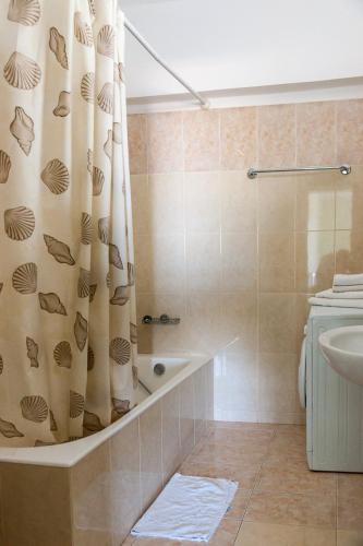 a bathroom with a shower curtain and a sink at Epidavros Seascape in Ancient Epidavros
