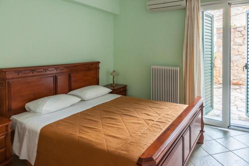 a bedroom with a large bed and a window at Epidavros Seascape in Ancient Epidavros