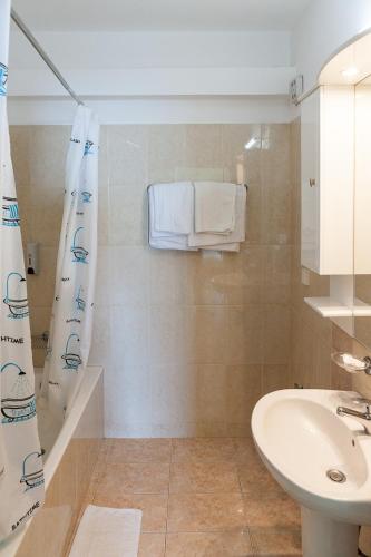a bathroom with a sink and a toilet and a shower at Epidavros Seascape in Ancient Epidavros