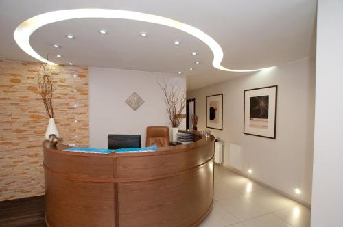 a lobby with a reception desk in a building at Bagińscy Spa in Pobierowo