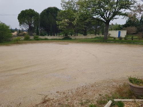 an empty parking lot with trees in the background at Hotel Carina in Apt