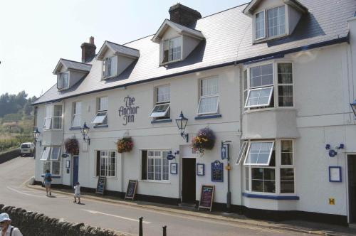 a white building on the side of a street at Anchor Inn by Greene King Inns in Beer