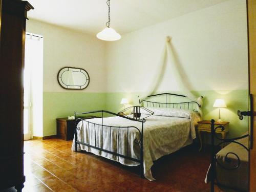 a bedroom with a bed in a room with green walls at Appartamento Borgo in Suvereto