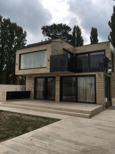 a house with large windows on the side of it at The Lake House in Fonyód