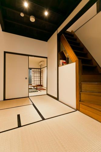an empty room with a staircase in a house at Hashiba-an in Kanazawa