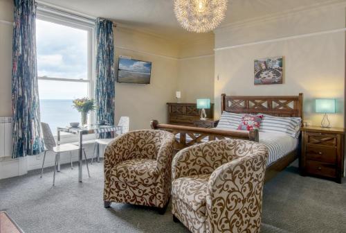 a bedroom with a bed and a table and chairs at Sea breeze in Whitby