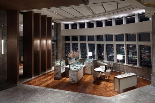 a rendering of a hotel lobby with a view of the city at Signiel Seoul in Seoul