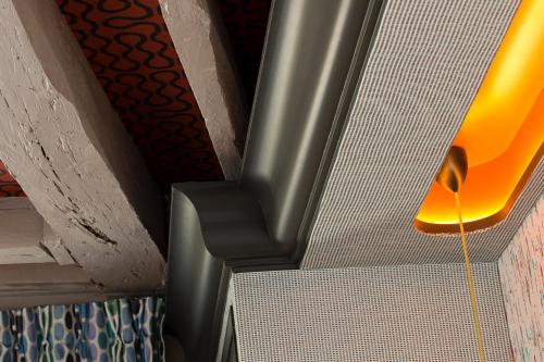 a yellow light hanging from the ceiling of a room at Hôtel Les Dames du Panthéon in Paris