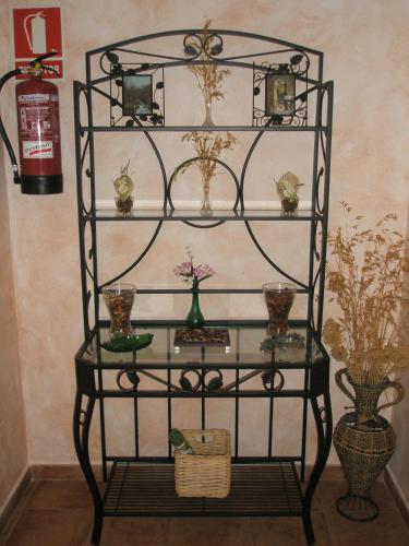 a shelf with glasses and vases on it at Hostal Zaguan in Talaveruela