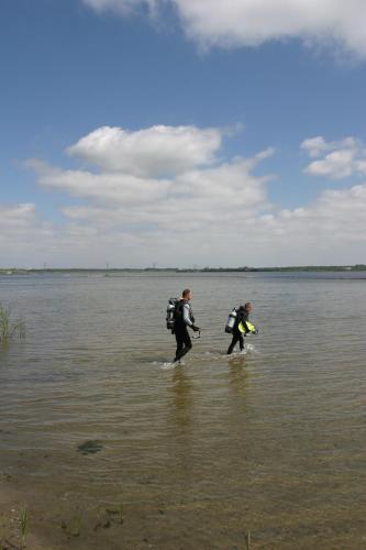 two people walking through a body of water at Bed & Breakfast Van Marion in Oostvoorne