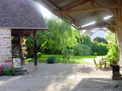 an outdoor pavilion with a picnic table and a fire hydrant at Chambre d'hotes Ferme de la Forlonge in Sauvigny-le-Beuréal