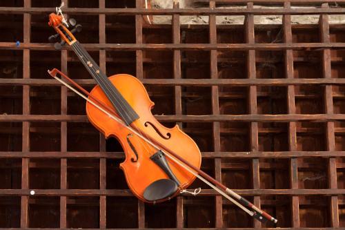 a violin is hanging on a metal grate at Mills Inn in Ballyvourney