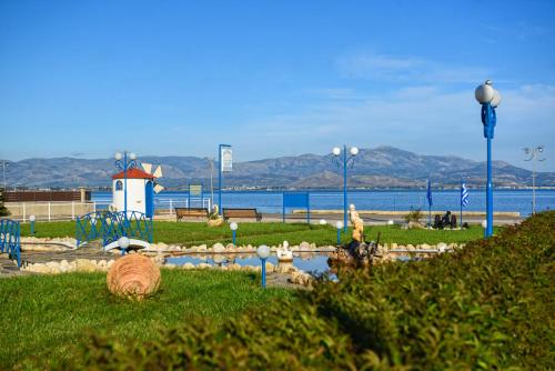 a park with a bunch of animals in the grass at Akrogiali in Míloi