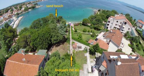 an aerial view of a house next to the ocean at Apartments Katić in Vantačići