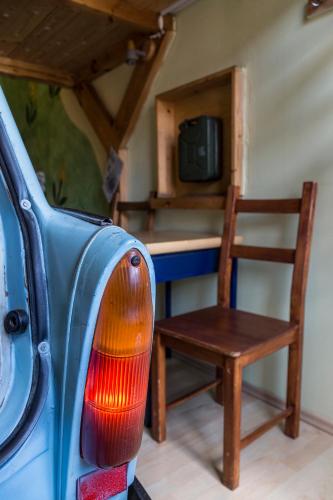 an old blue car with a chair and a table at Hostel Lollis Homestay Dresden in Dresden