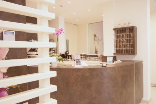 a store with a counter in the middle of a room at Hotel Myosotis in Riccione