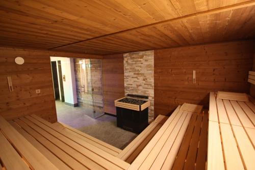 an empty wooden sauna with a stove in it at Sport Hotel in Livigno